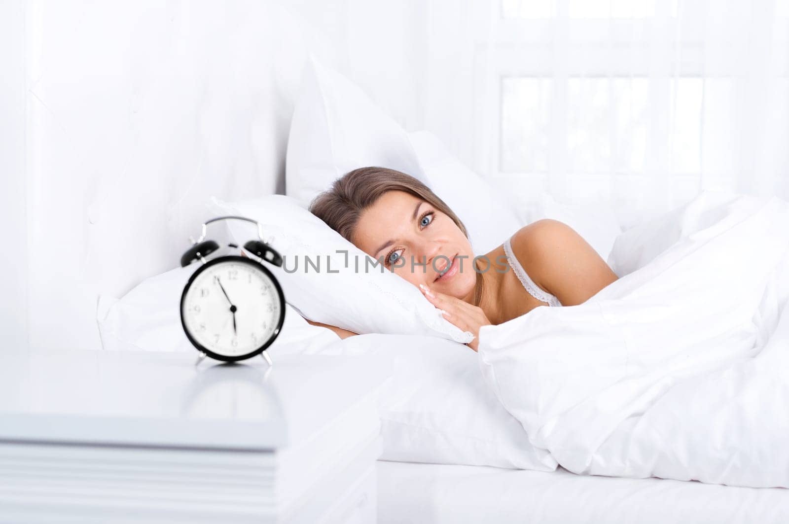 Woman in bed waking up