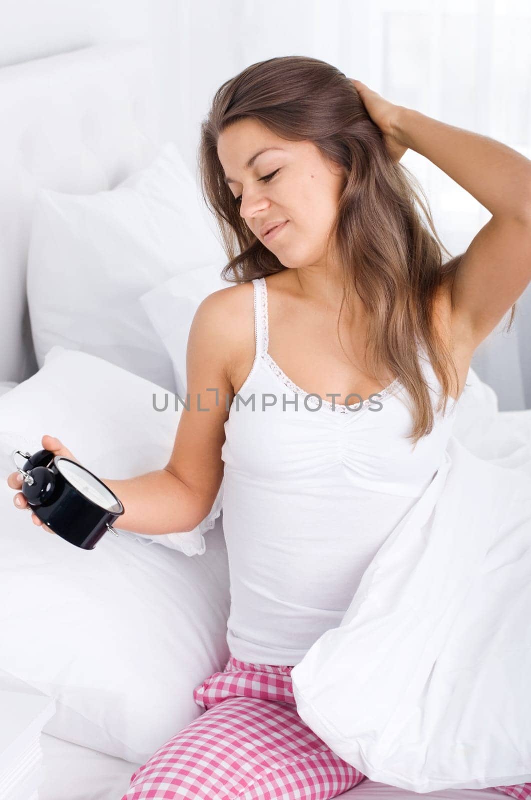 Woman in bed waking up