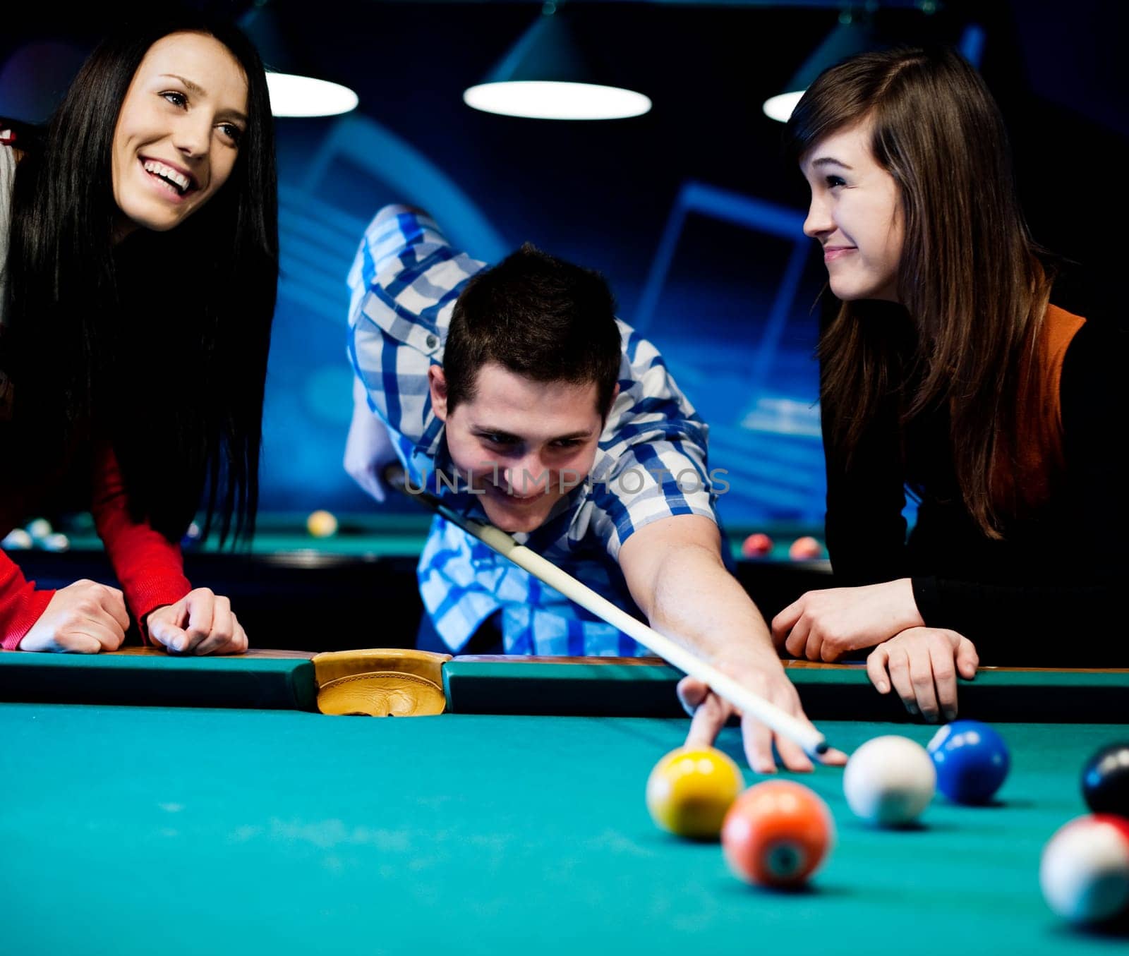 Friends playing billiard