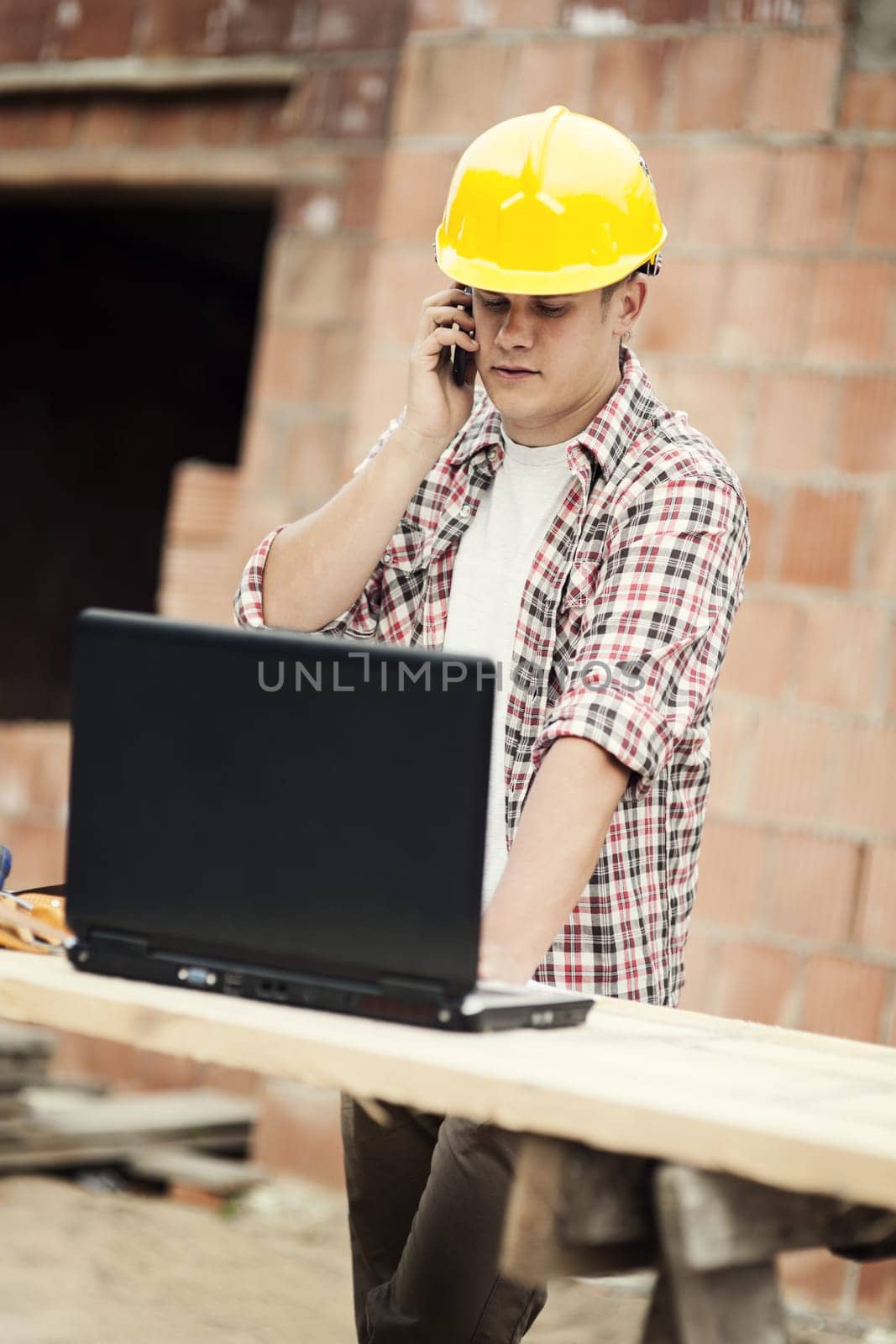 Carpenter talking on mobile phone