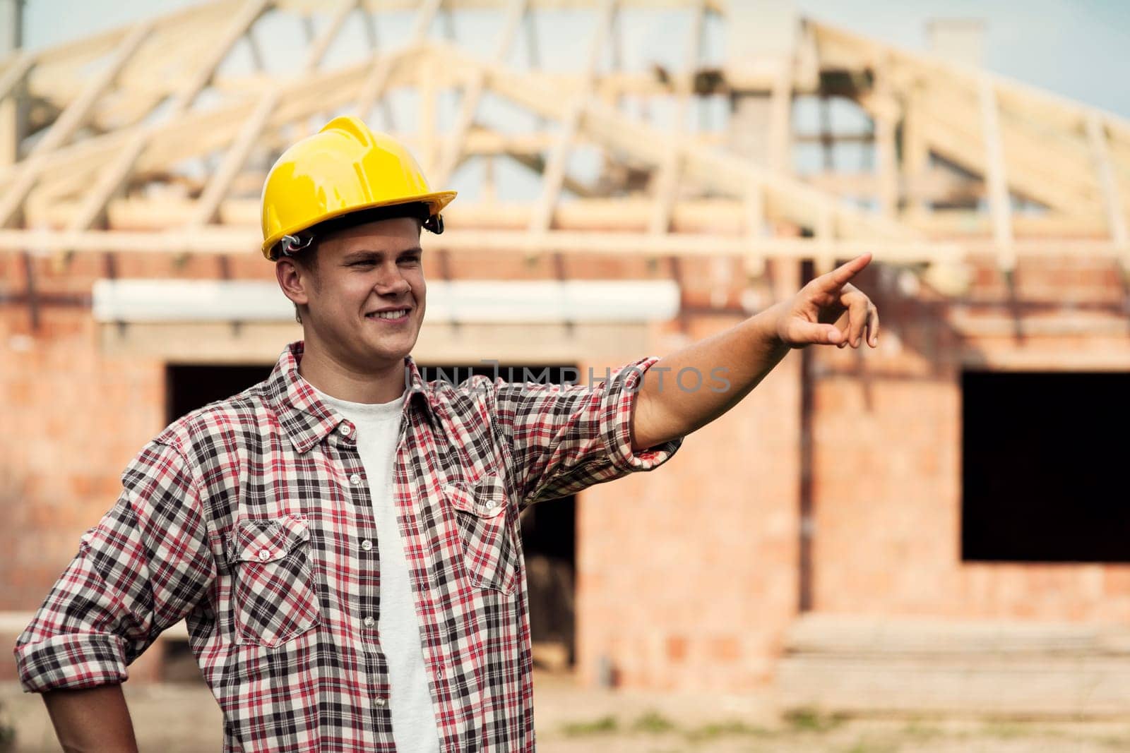 Construction worker pointing at something