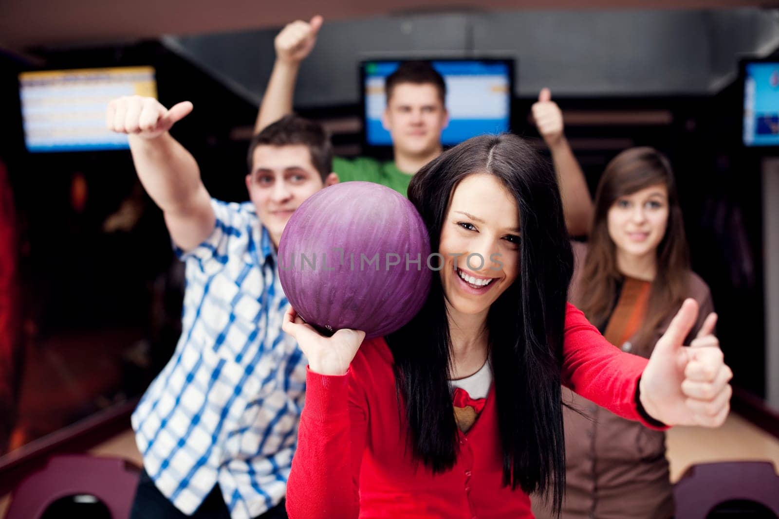Friends bowling together