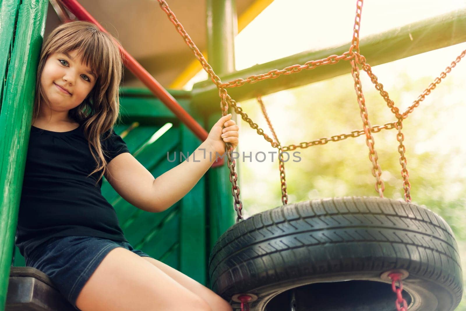 Portrait of happy, little girl on playground