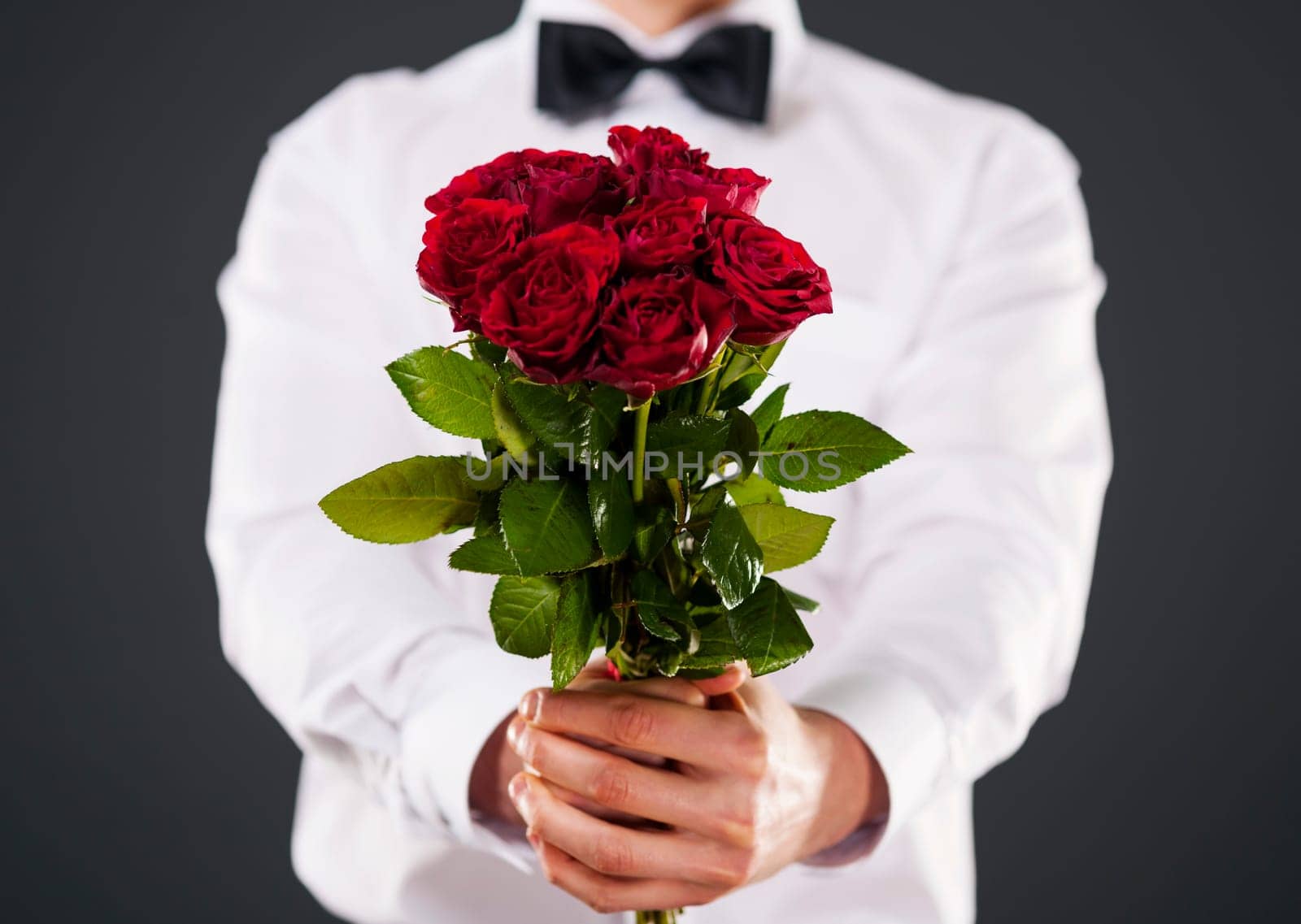 Man giving bouquet of red roses