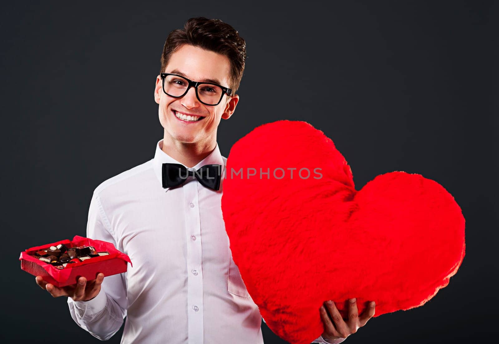 Man holding heart shape and box of chocolate