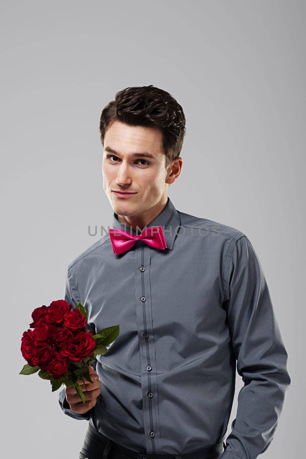 Handsome man holding red roses