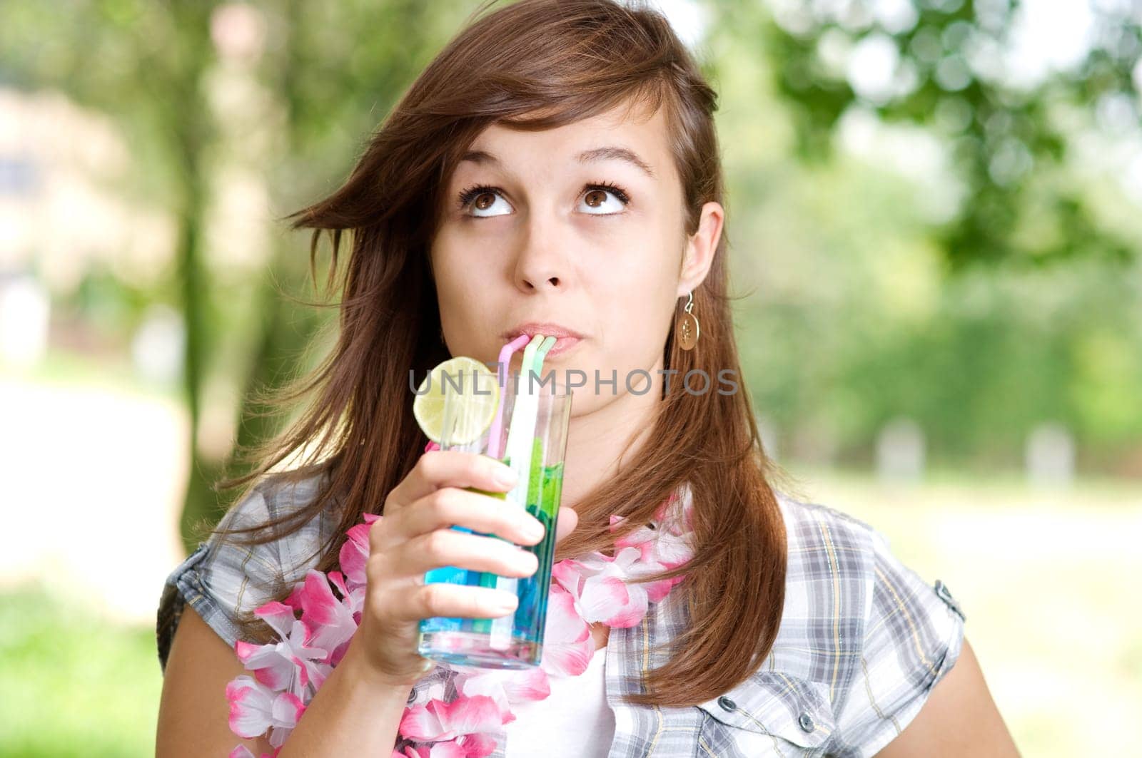 Young woman drinking blue curacao cocktail