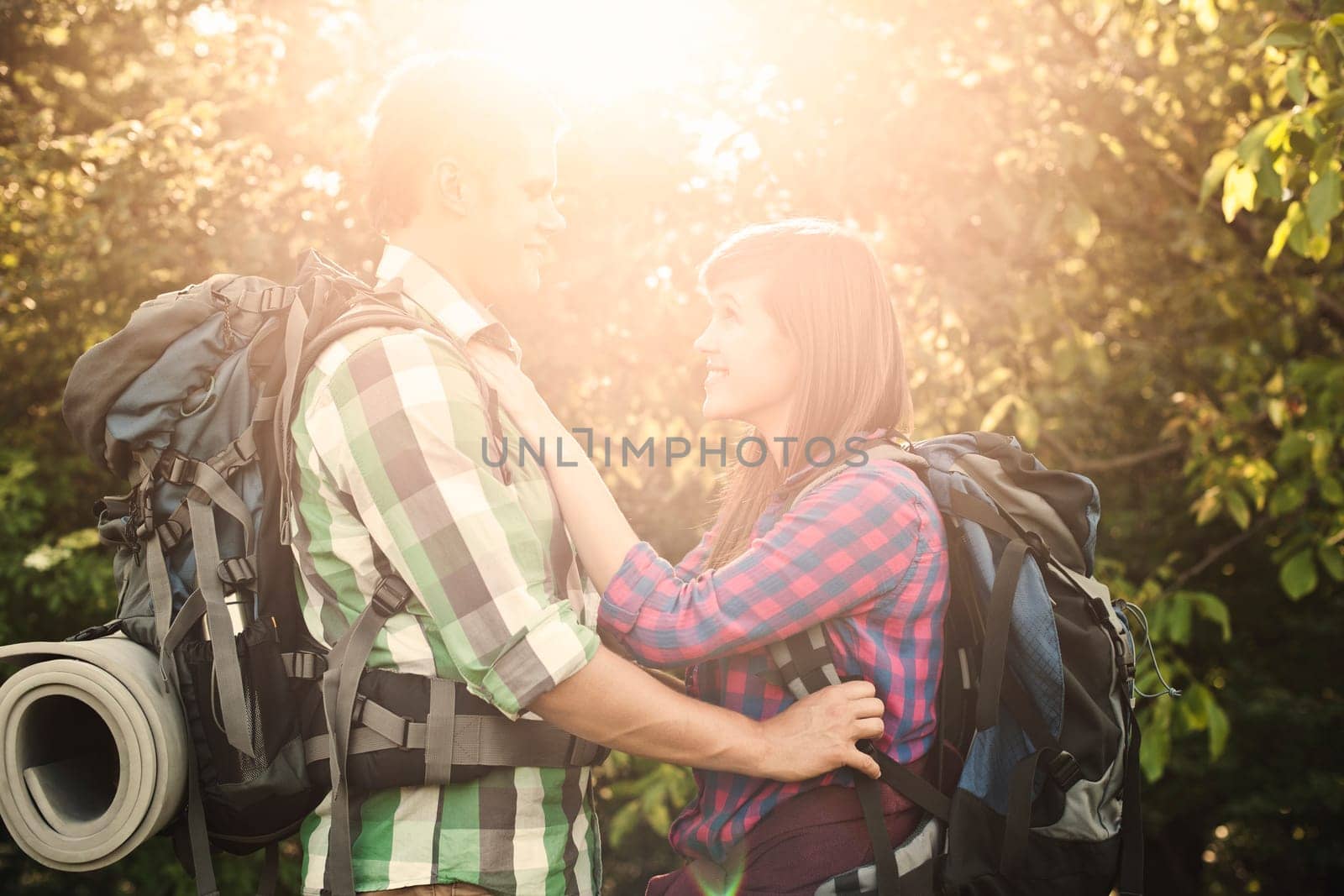 Loving couple in forest at sunset