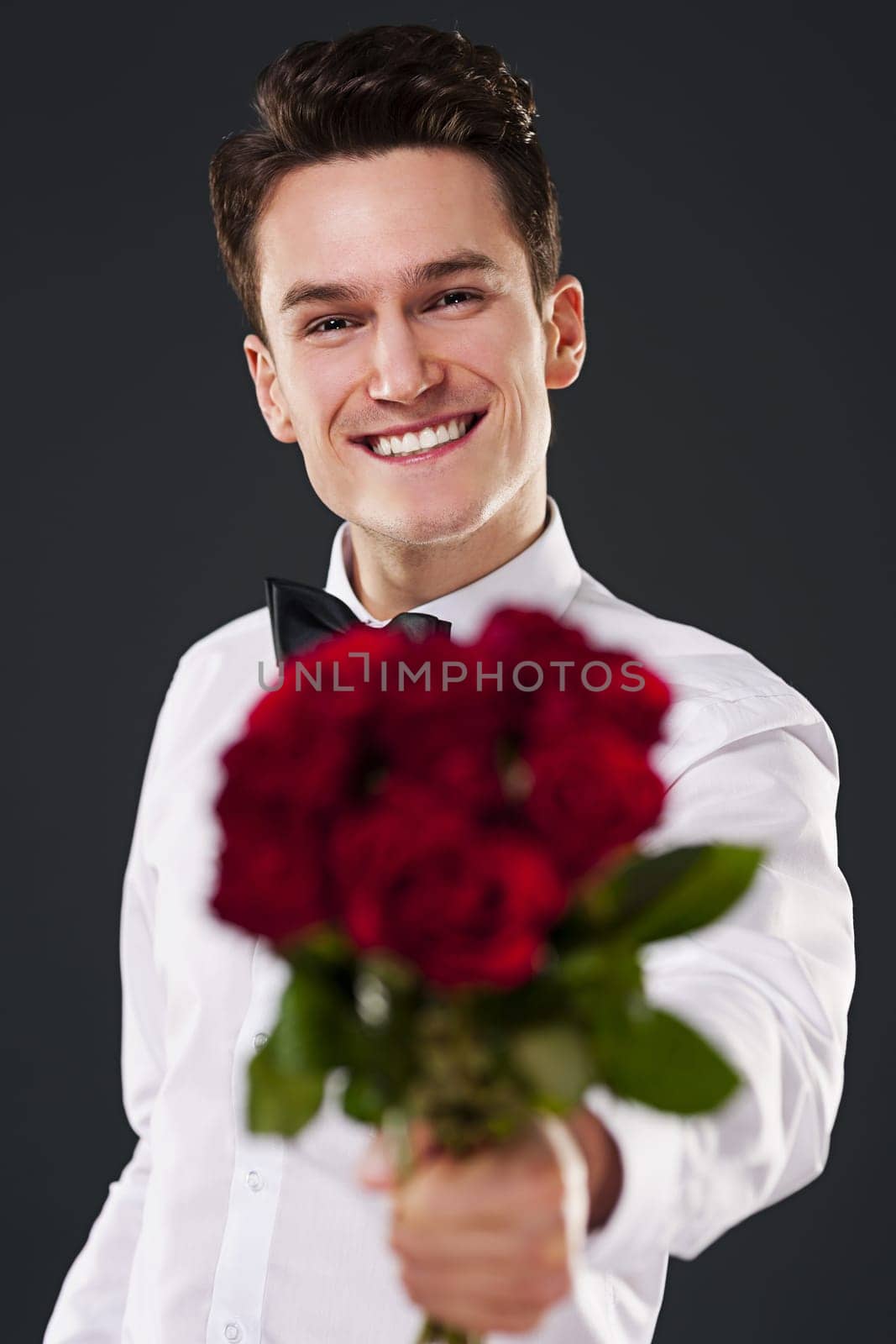Man giving bouquet of red roses
