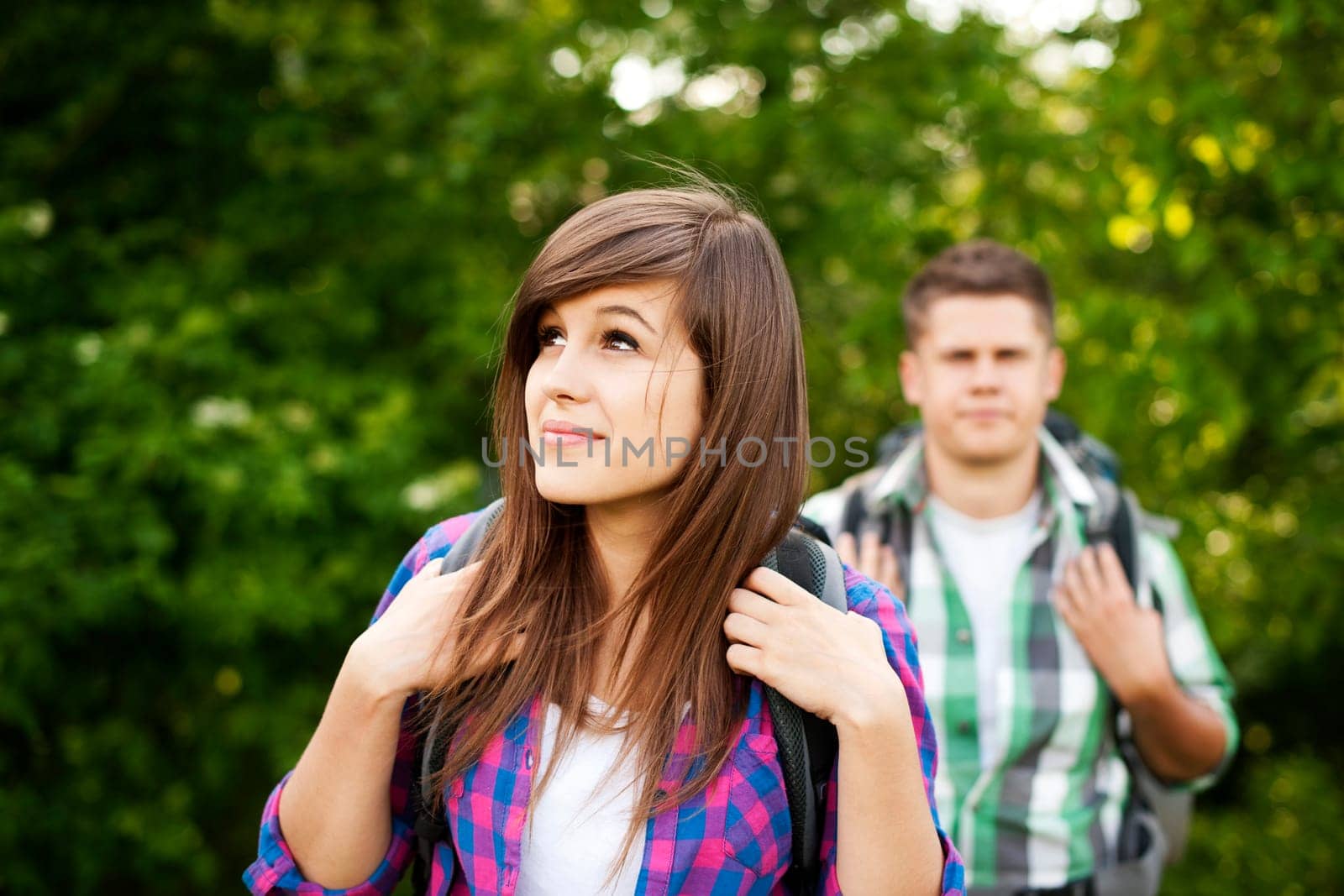 Young couple walking through forest