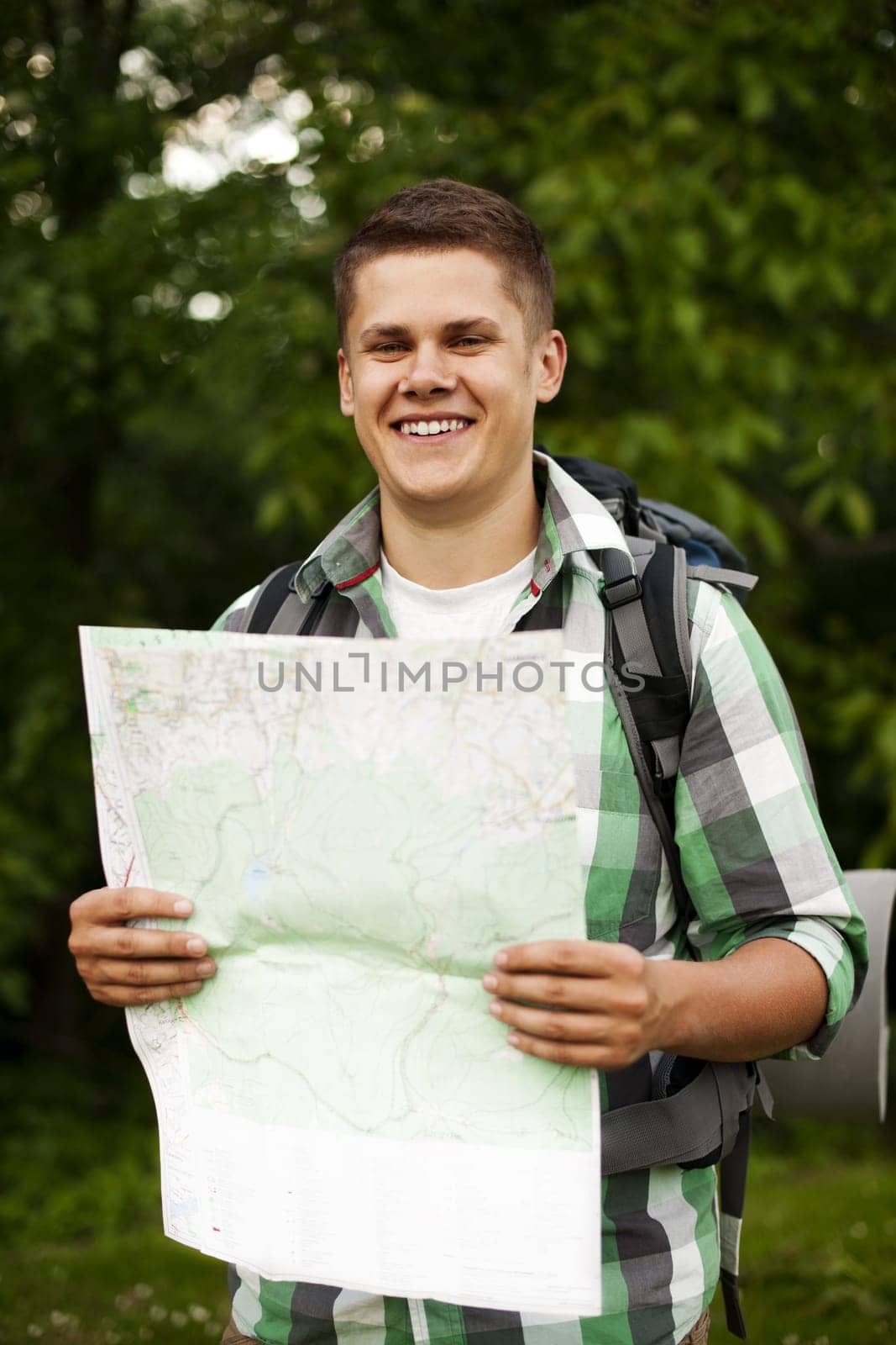 Man holding a map in forest