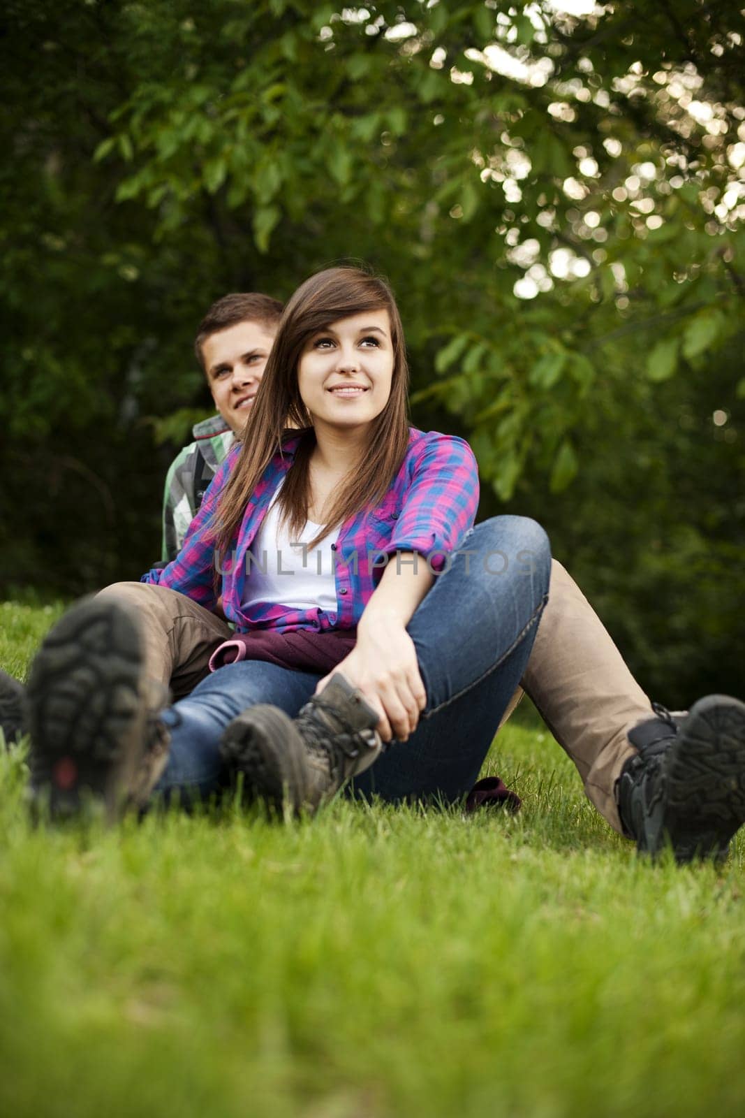 Young couple sitting on glade