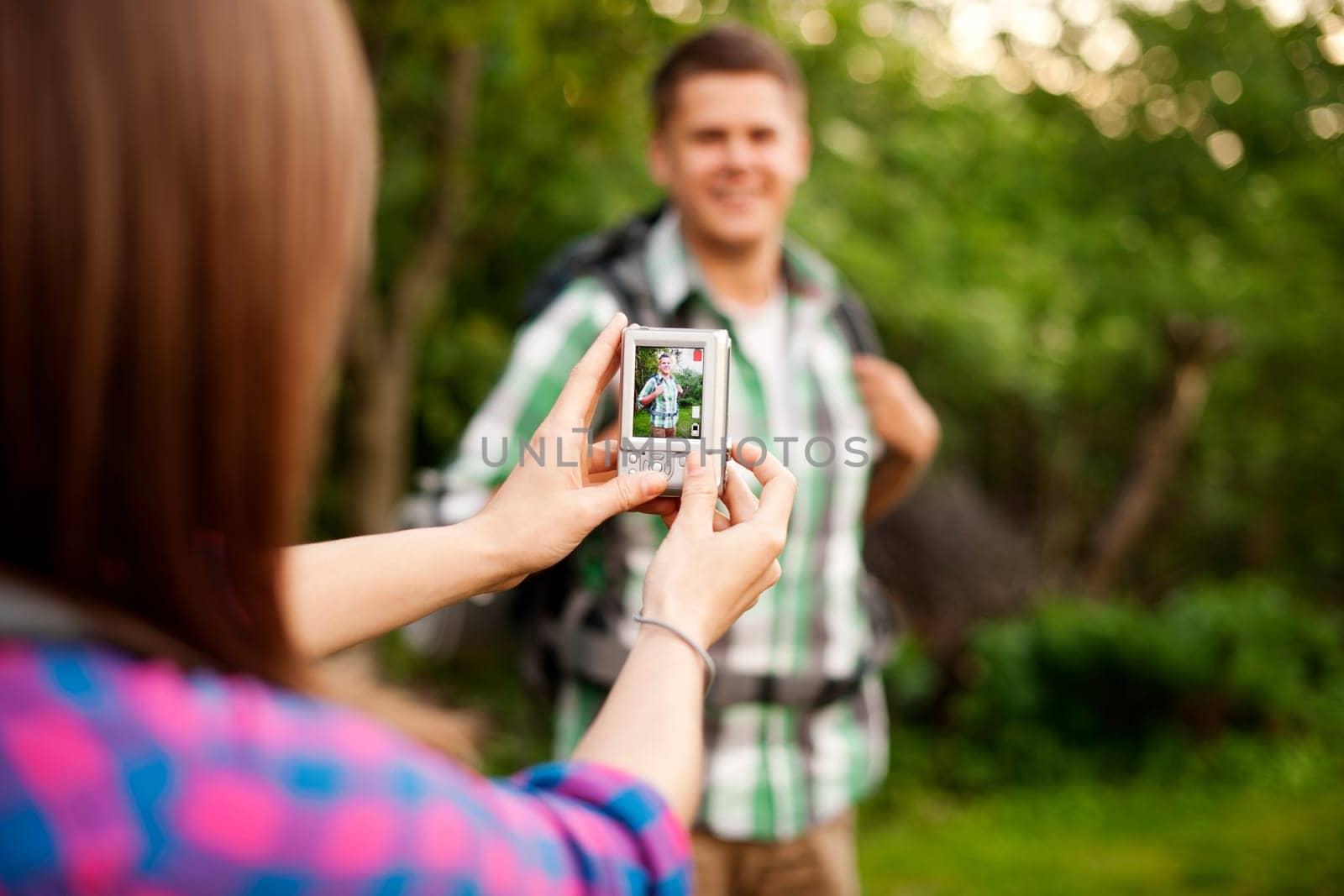 Young woman taking photo for her boyfriend