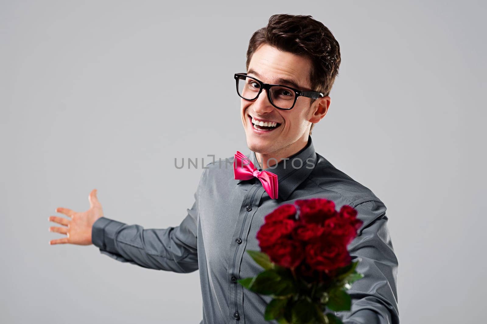 Cute nerd with a bouquet of roses