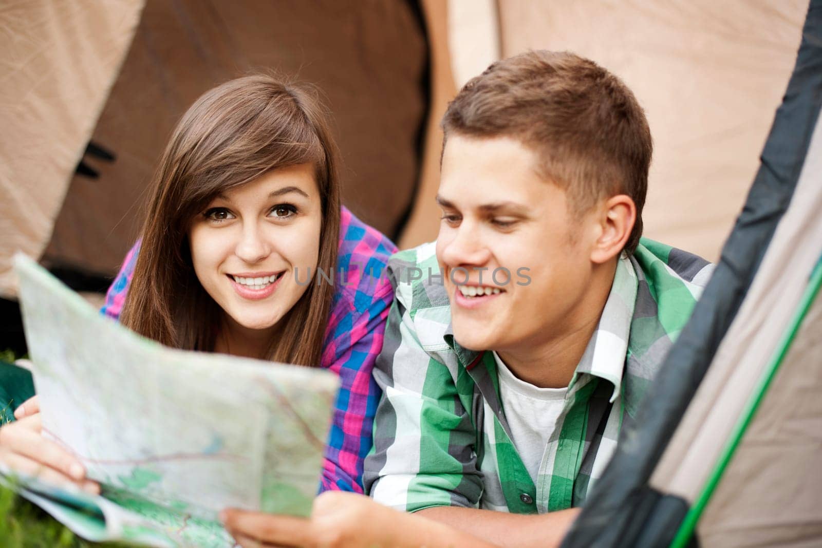 Couple looking at map in tent