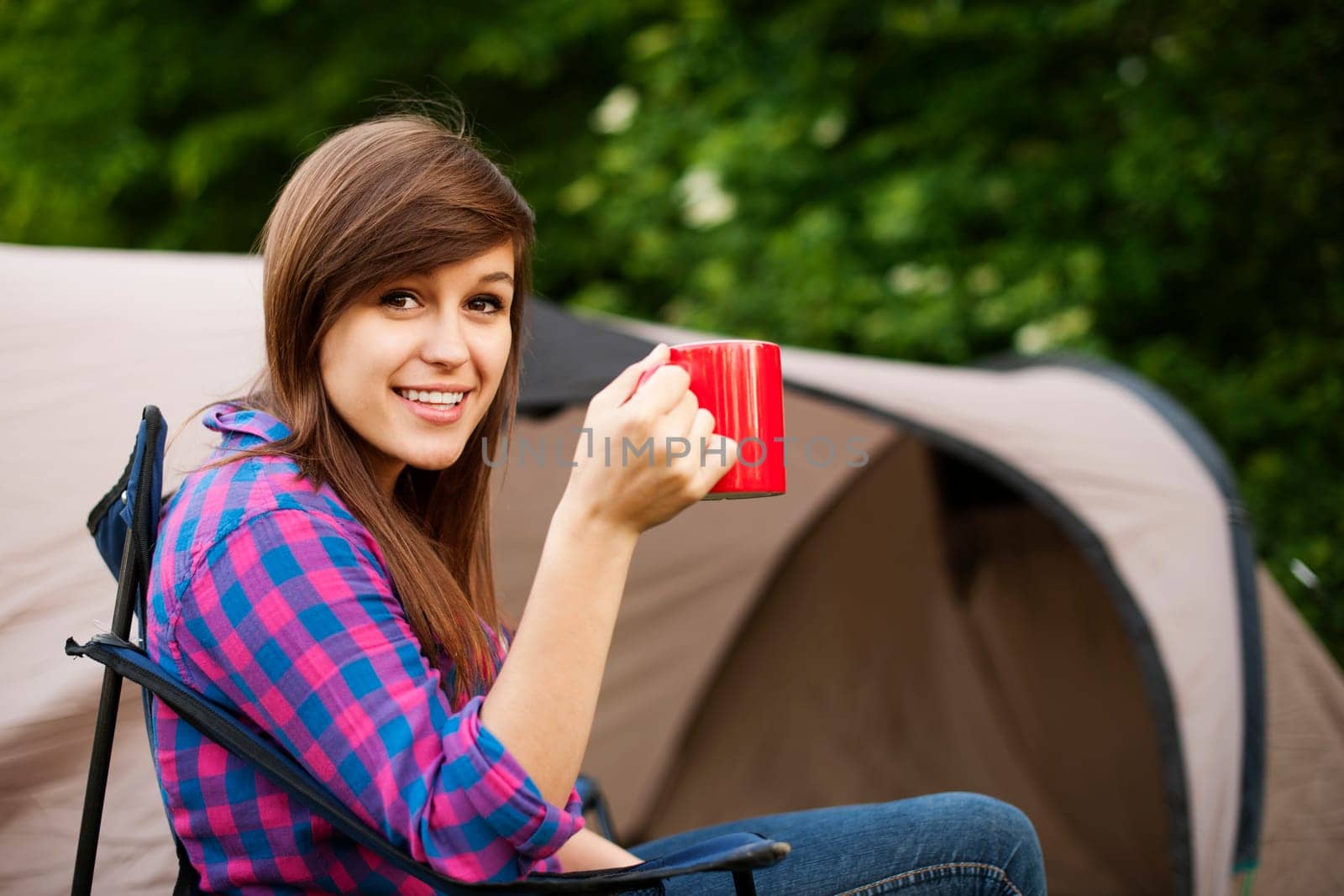 Young woman sitting in front of the tent