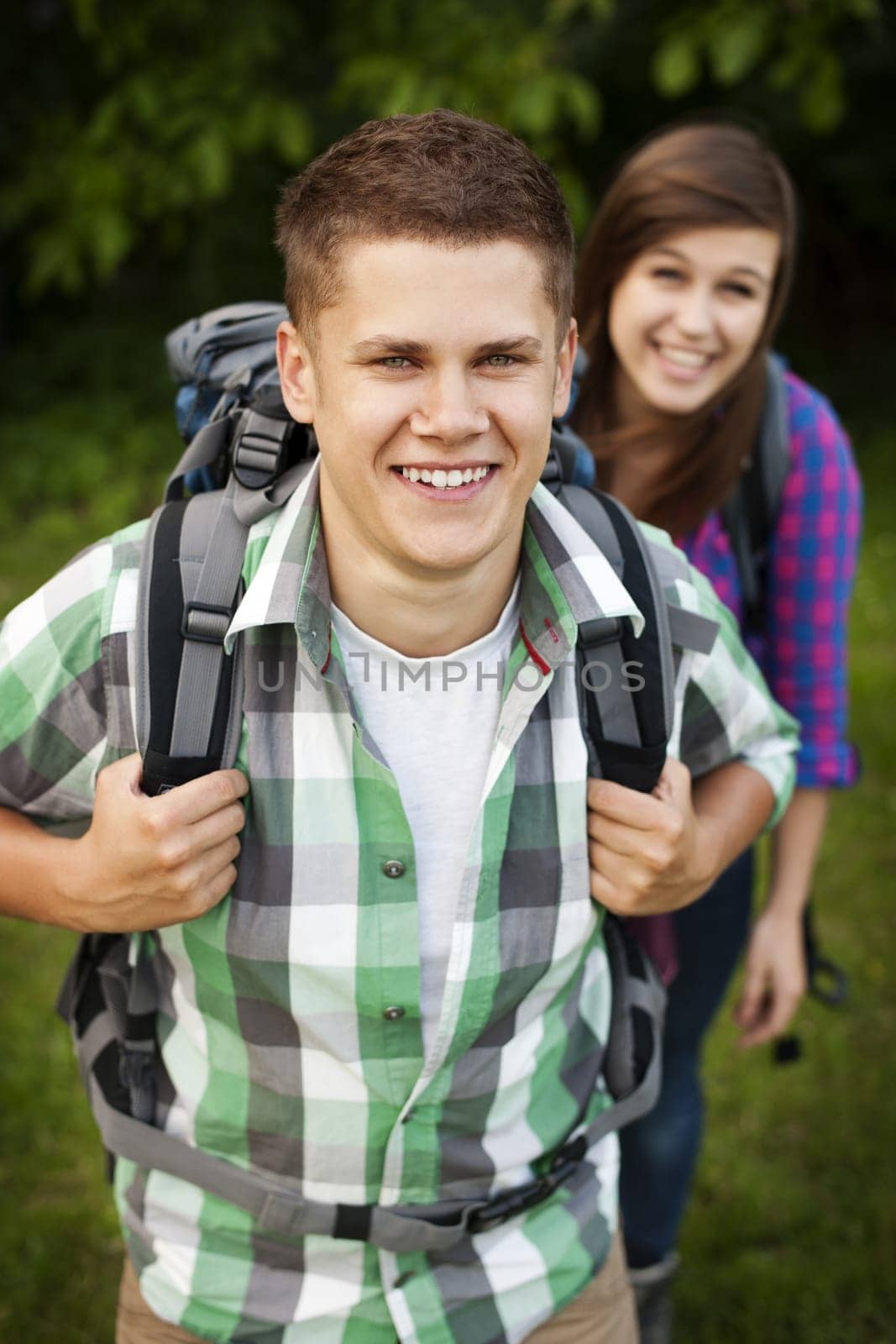Young couple walking through forest
