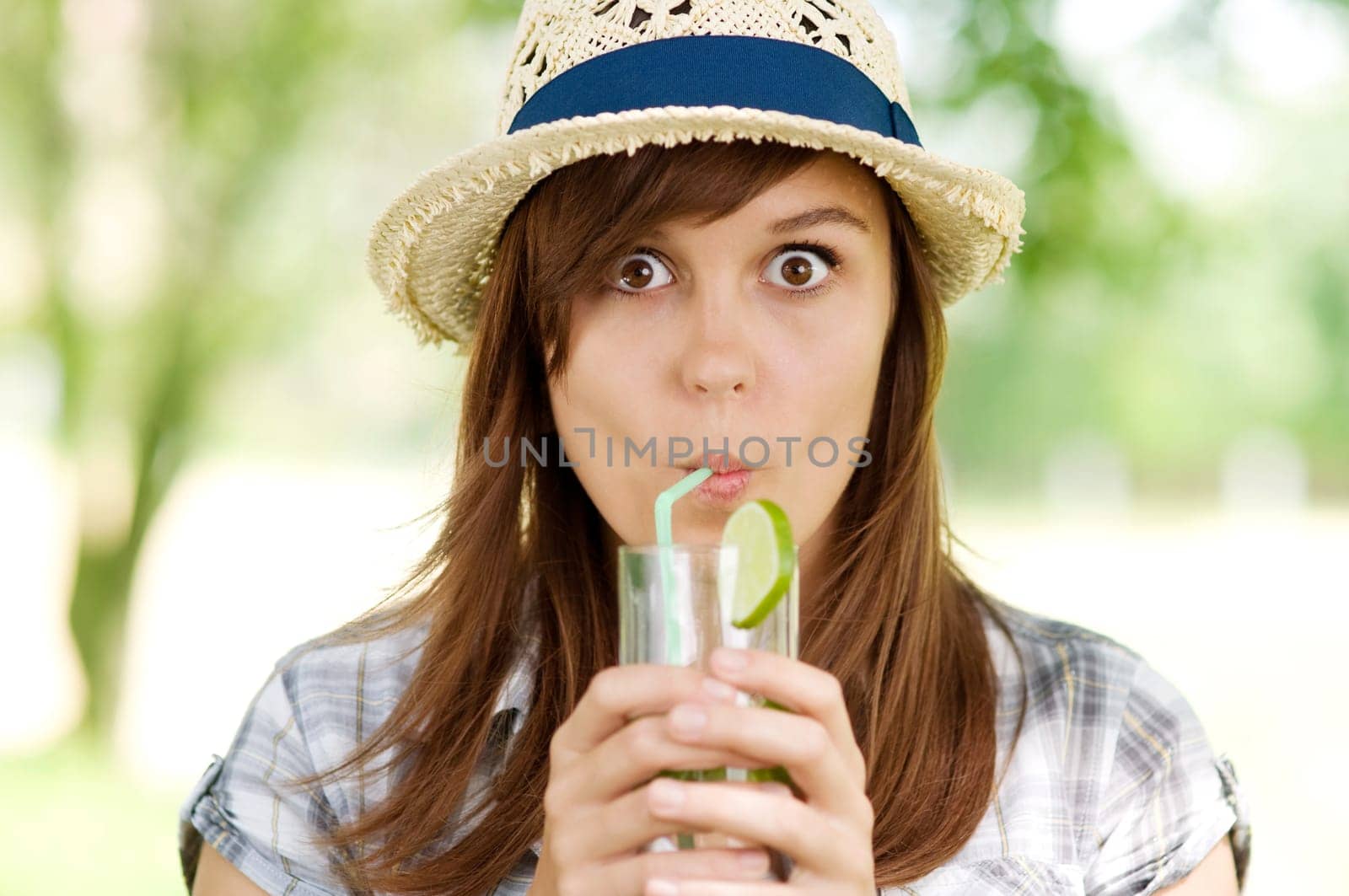 Young woman drinking mojito