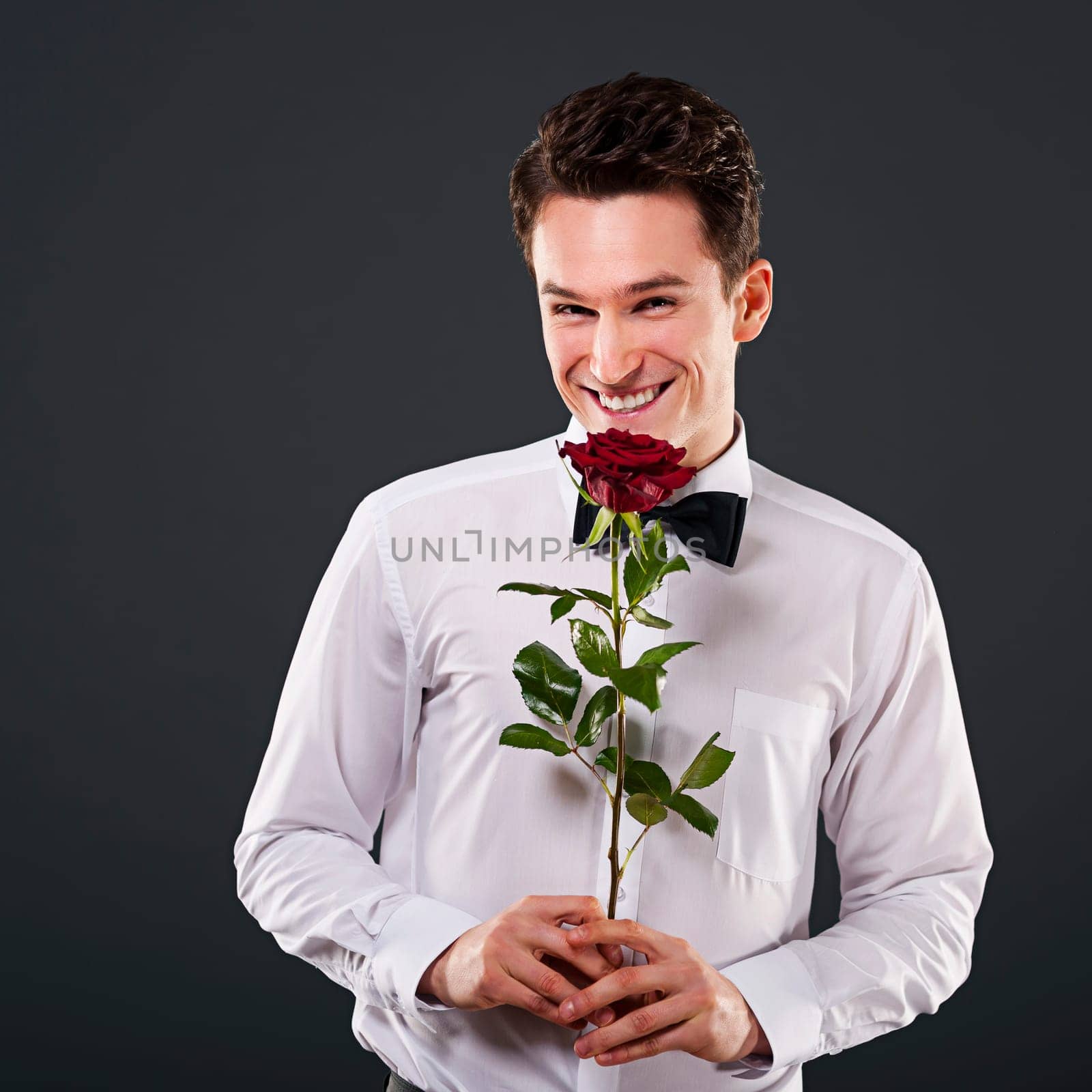 Smiling man with red rose