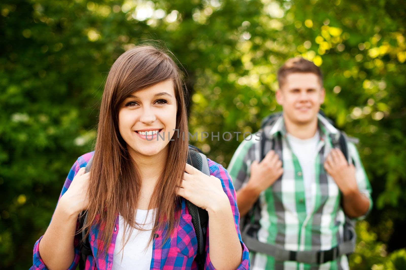 Young couple walking through forest