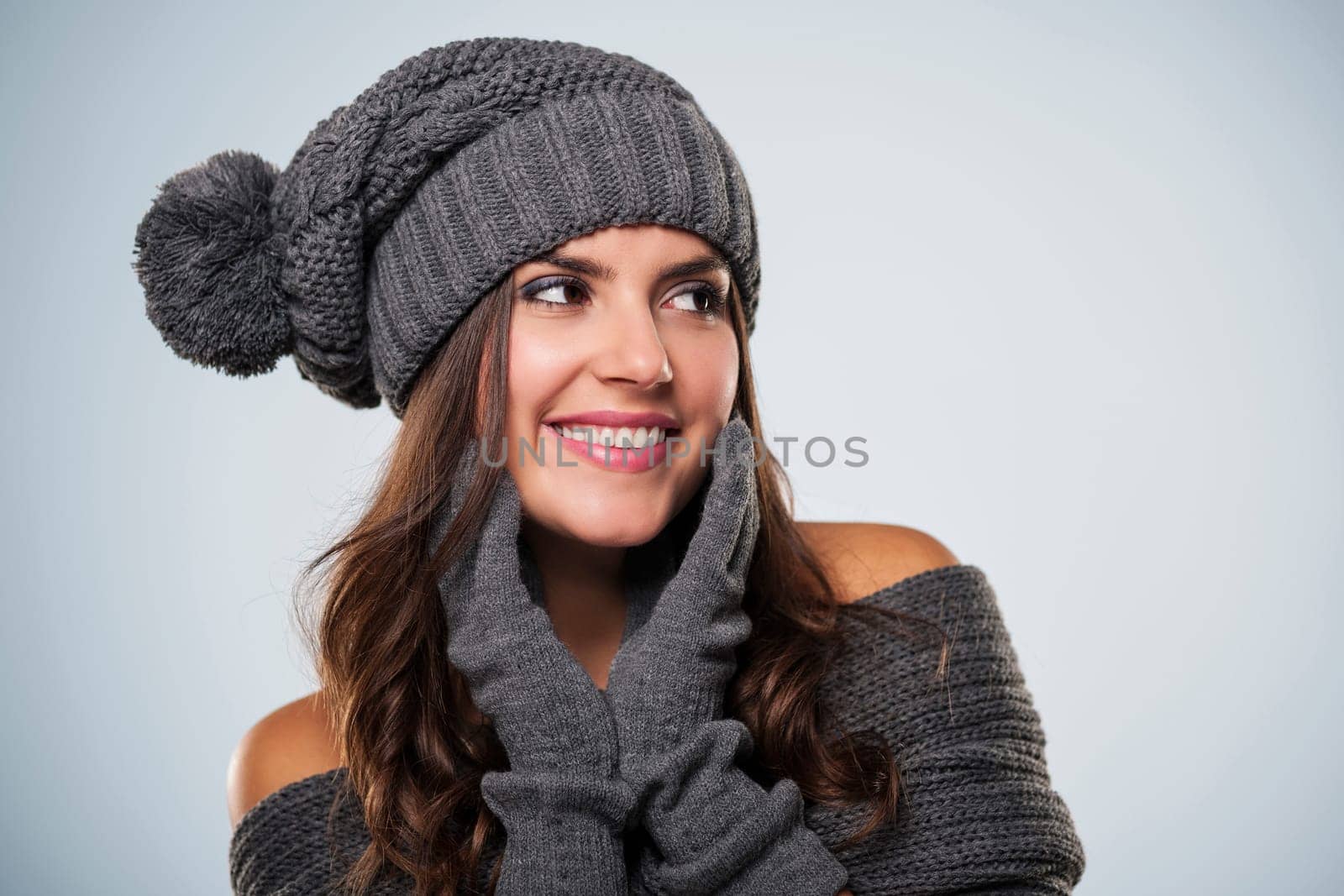 Gorgeous young woman wearing winter clothing looking at copy space