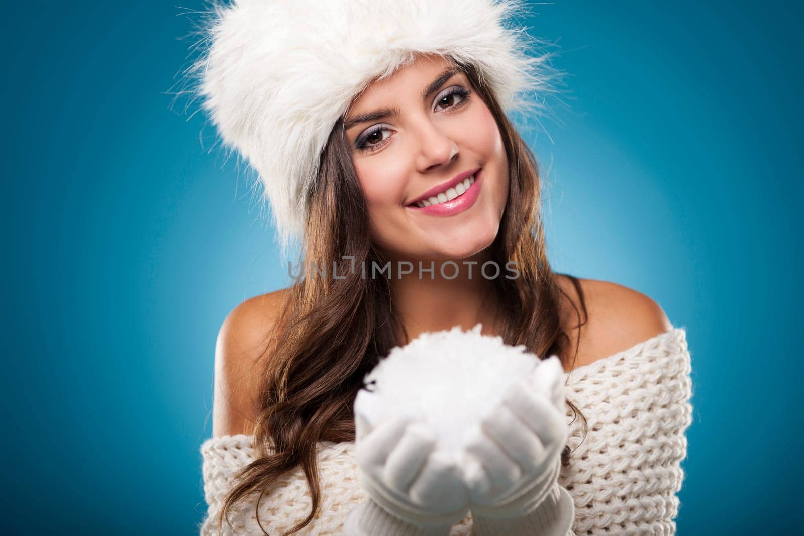Portrait of beautiful winter woman with snowball