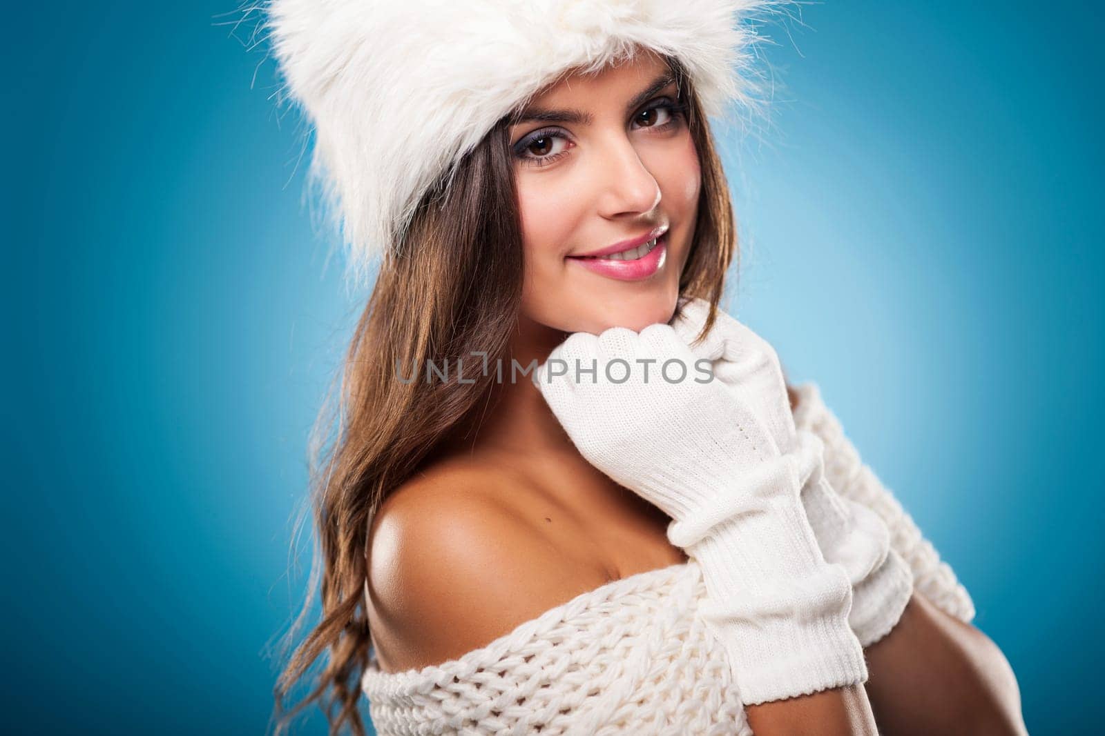 Portrait of gorgeous winter woman wearing fur hat