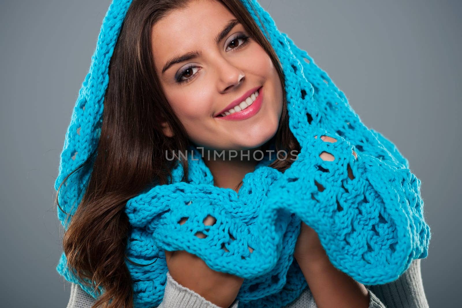 Portrait of beautiful woman wearing big blue scarf