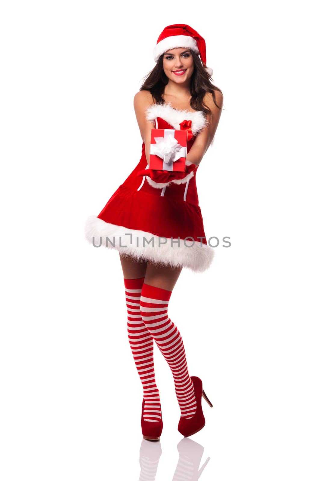 Smiling santa claus woman giving red christmas gift