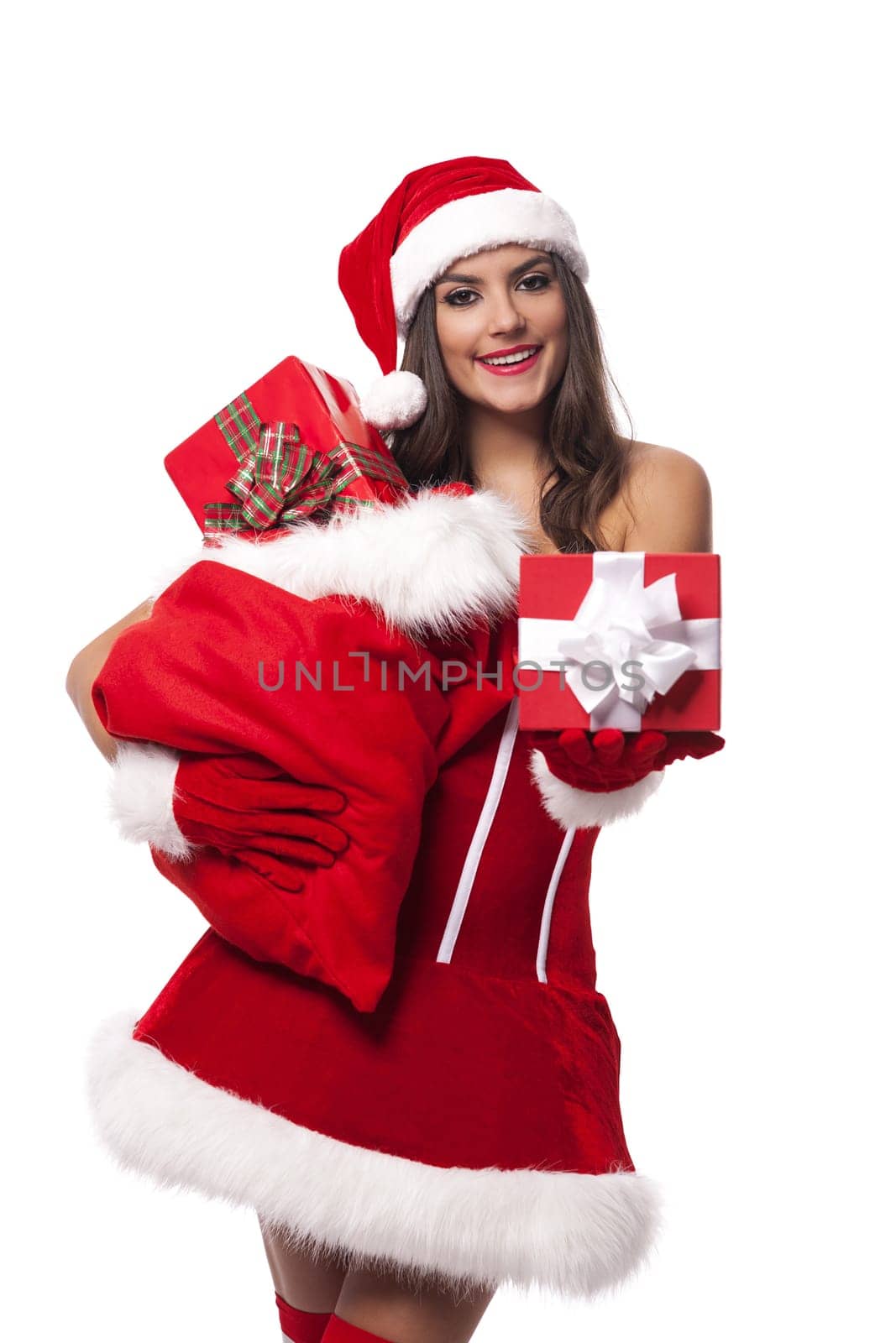 Sexy woman giving christmas gifts from sack of santa claus