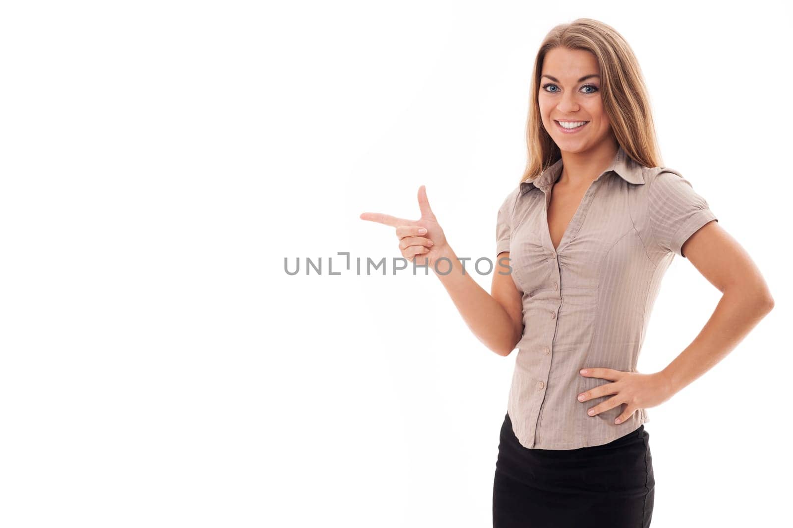 Beautiful businesswoman pointing at copyspace