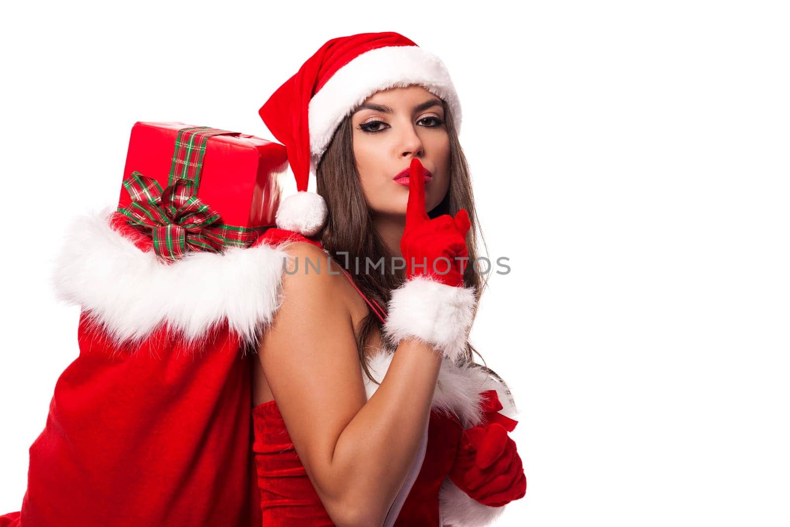Sexy santa claus woman with christmas sack saying shh