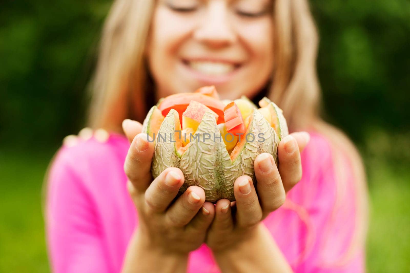 Young woman holding fruits and vegetables