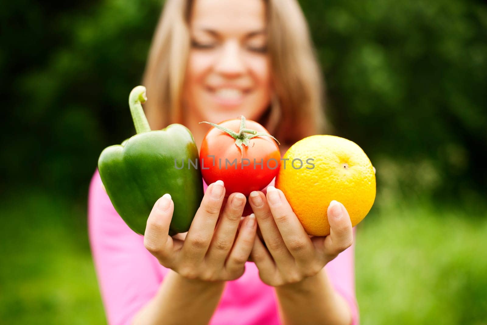 Young woman holding fruits and vegetables