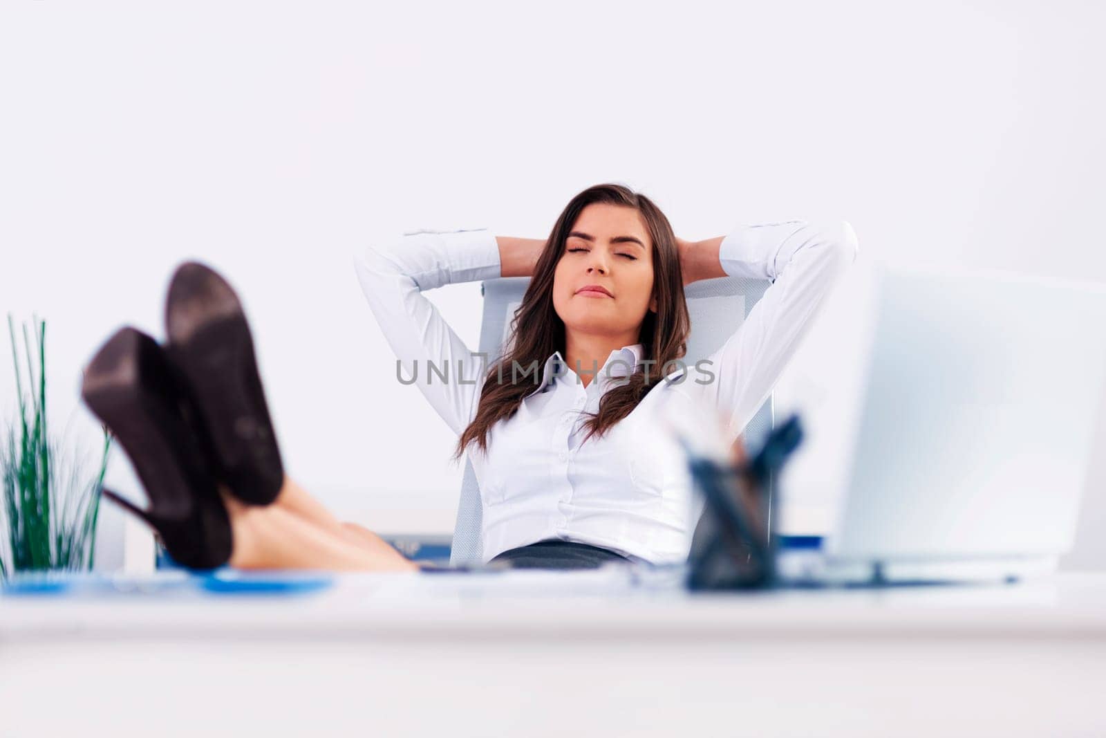 Young businesswoman relaxing in office
