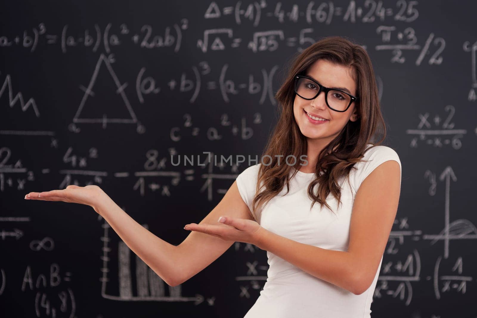 Woman wearing in glasses showing mathematical formulas