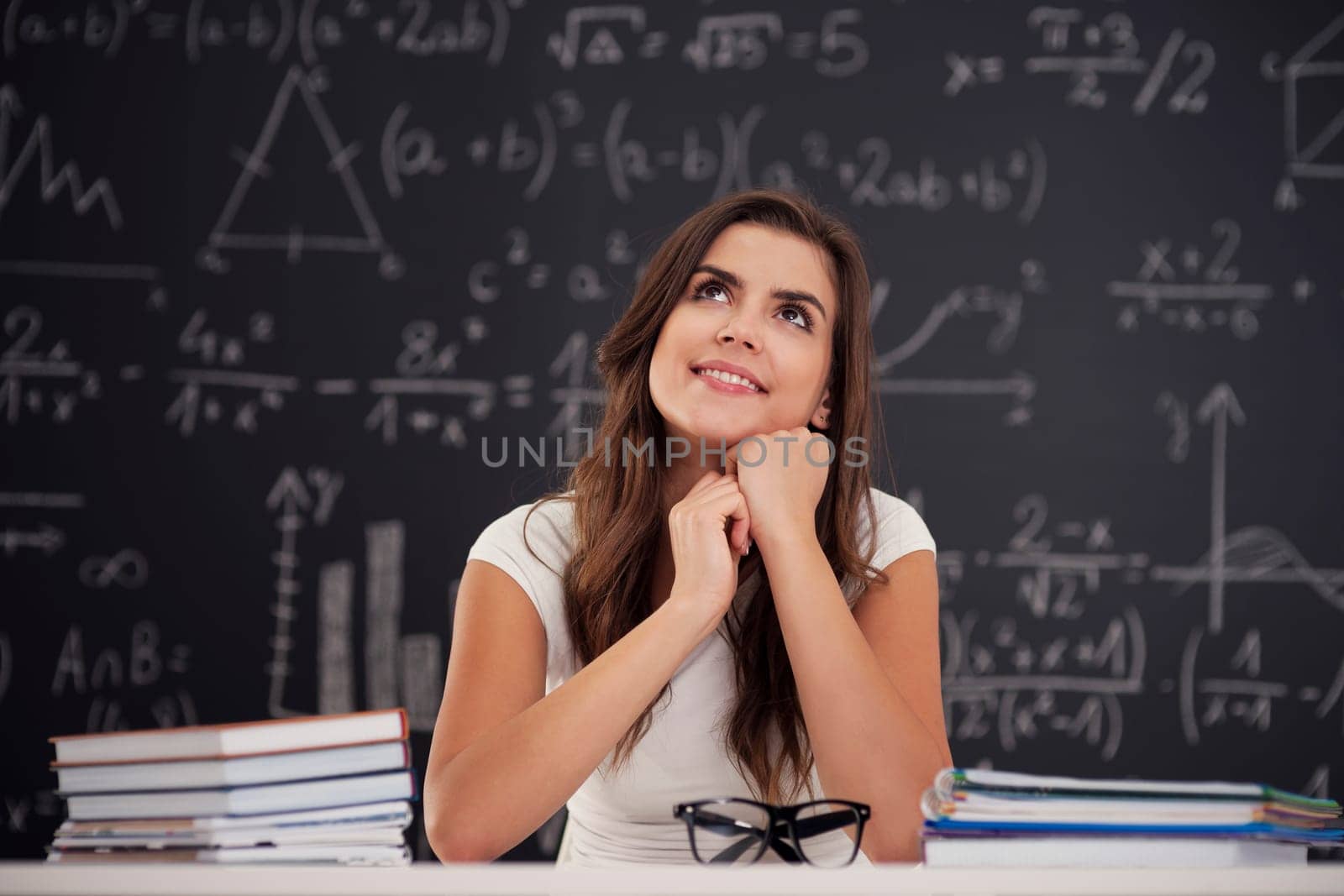 Happy woman sitting in classroom and looking up
