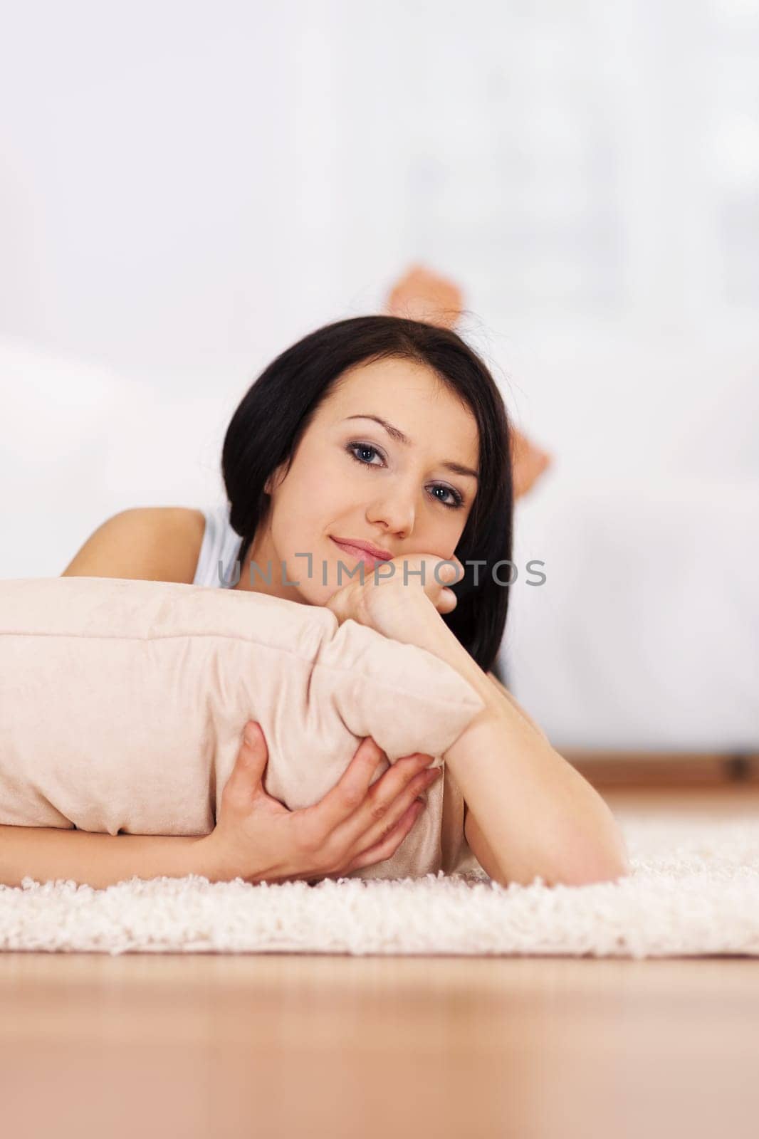 Brunette woman lying down on the carpet