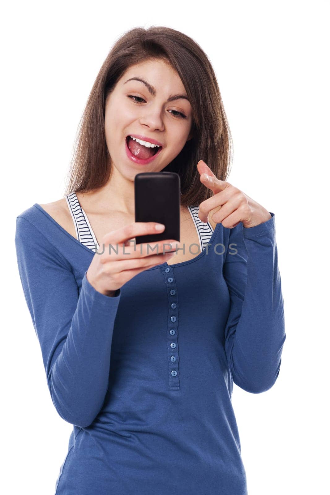 Excitement woman with mobile phone pointing at camera