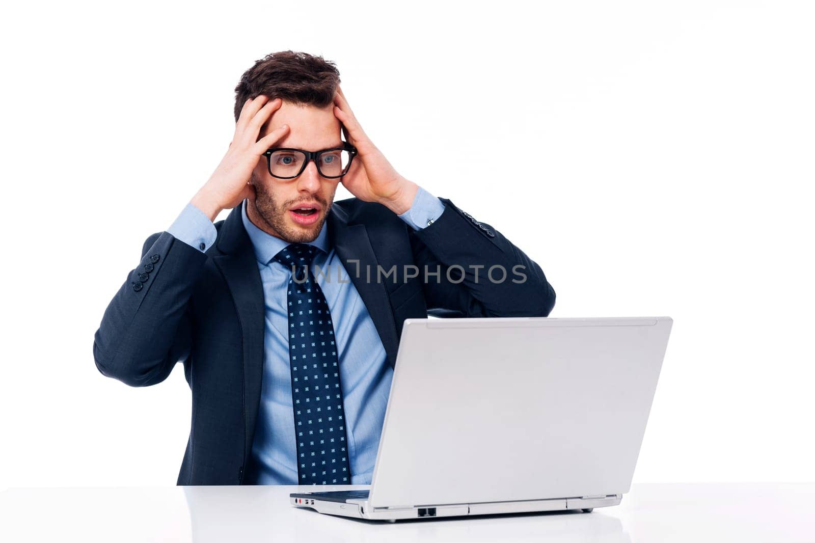 Shocked businessman looking at laptop