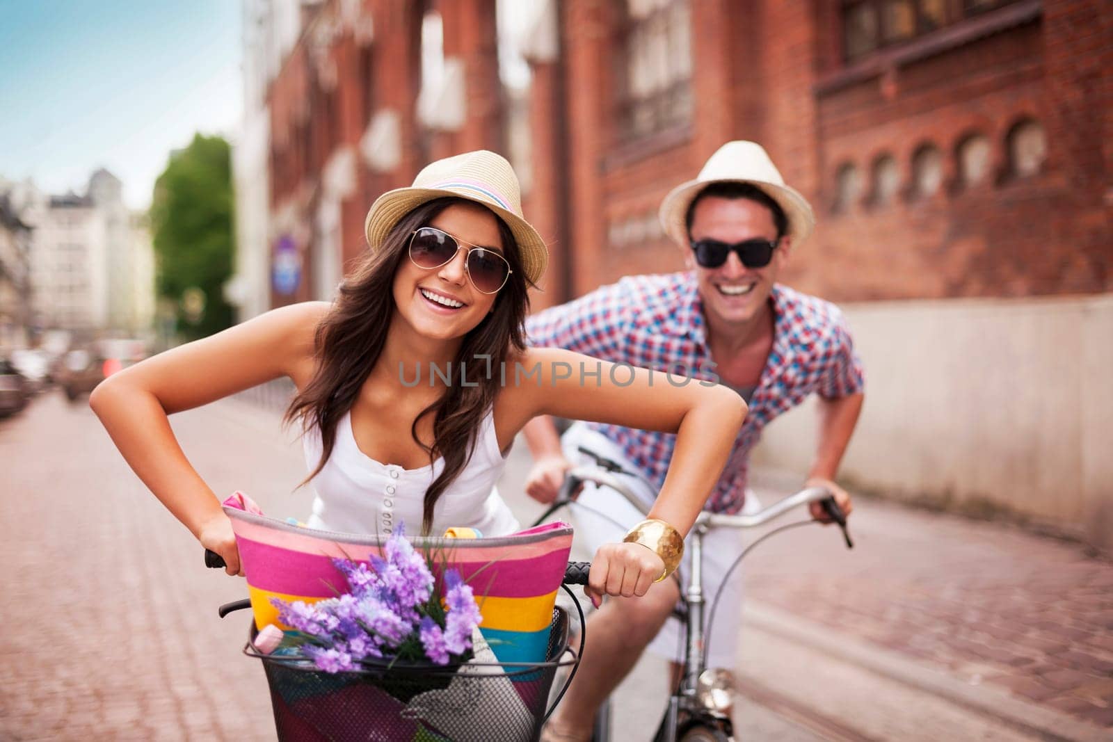 Happy couple cycling in the city