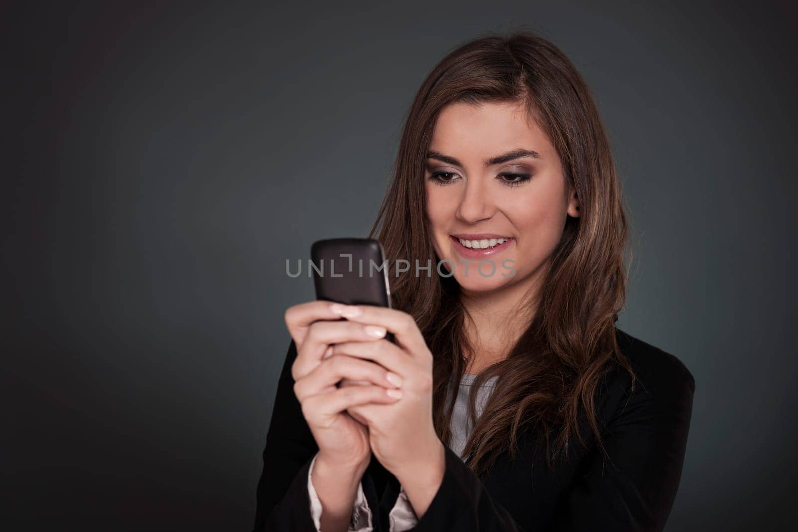 Businesswoman text messaging