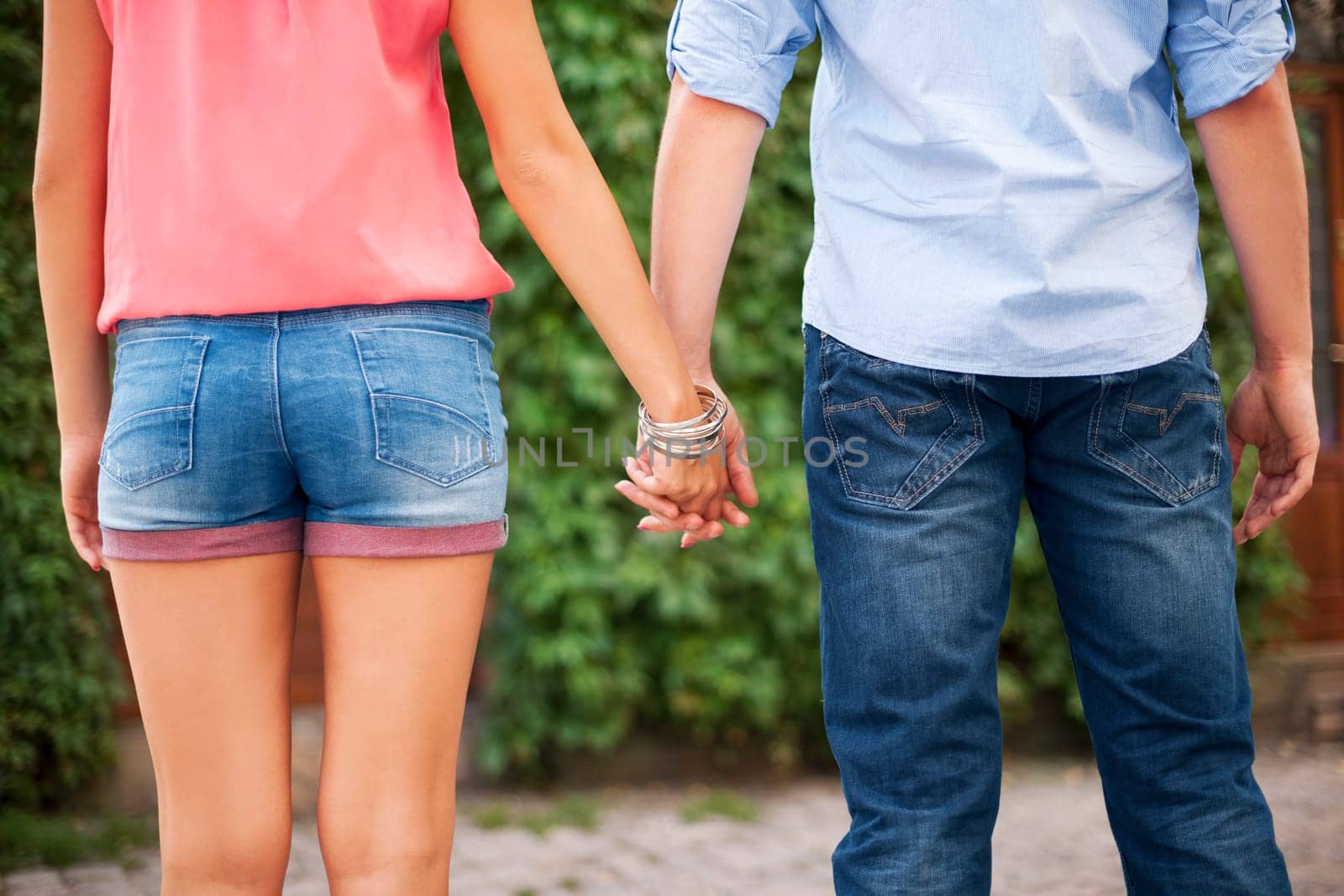 Closeup of young couple holding hands