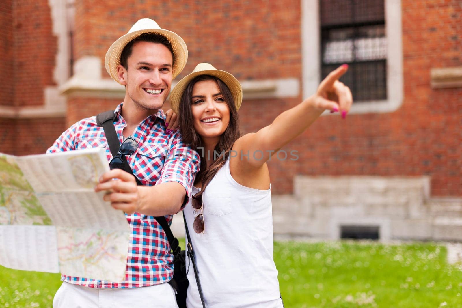 Woman pointing at something to her boyfriend during sightseeing