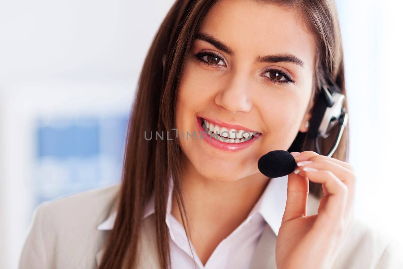 Happy female wearing headset and looking at camera