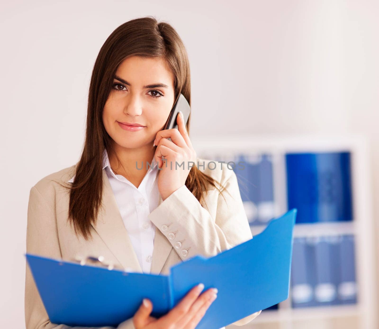 Busy businesswoman in talking on smart phone
