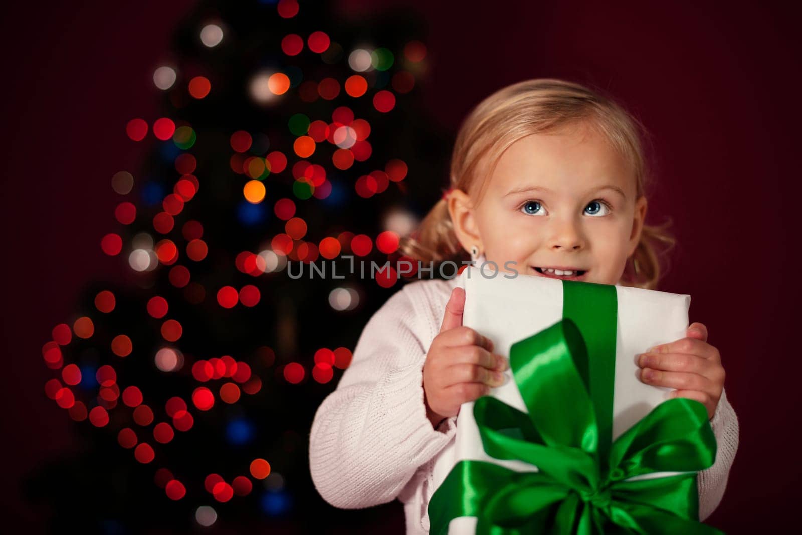Little girl holding christmas gift