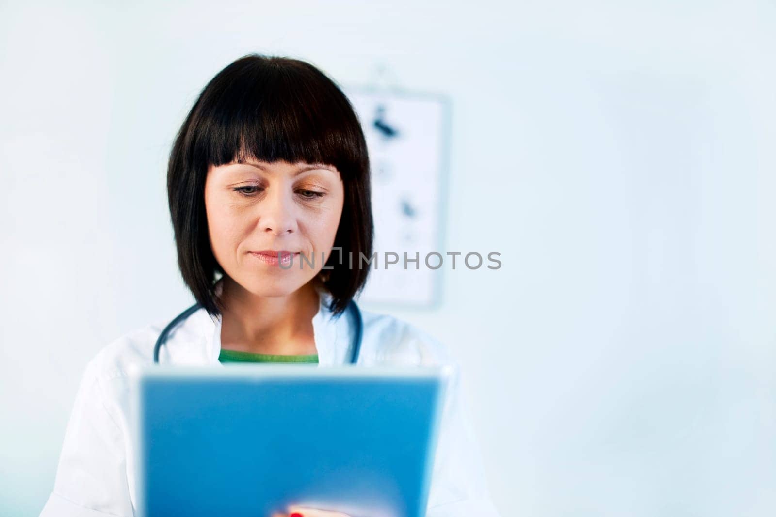 Female doctor holding tablet