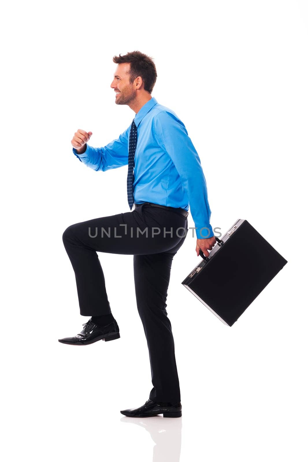 Self confident businessman climbing for success