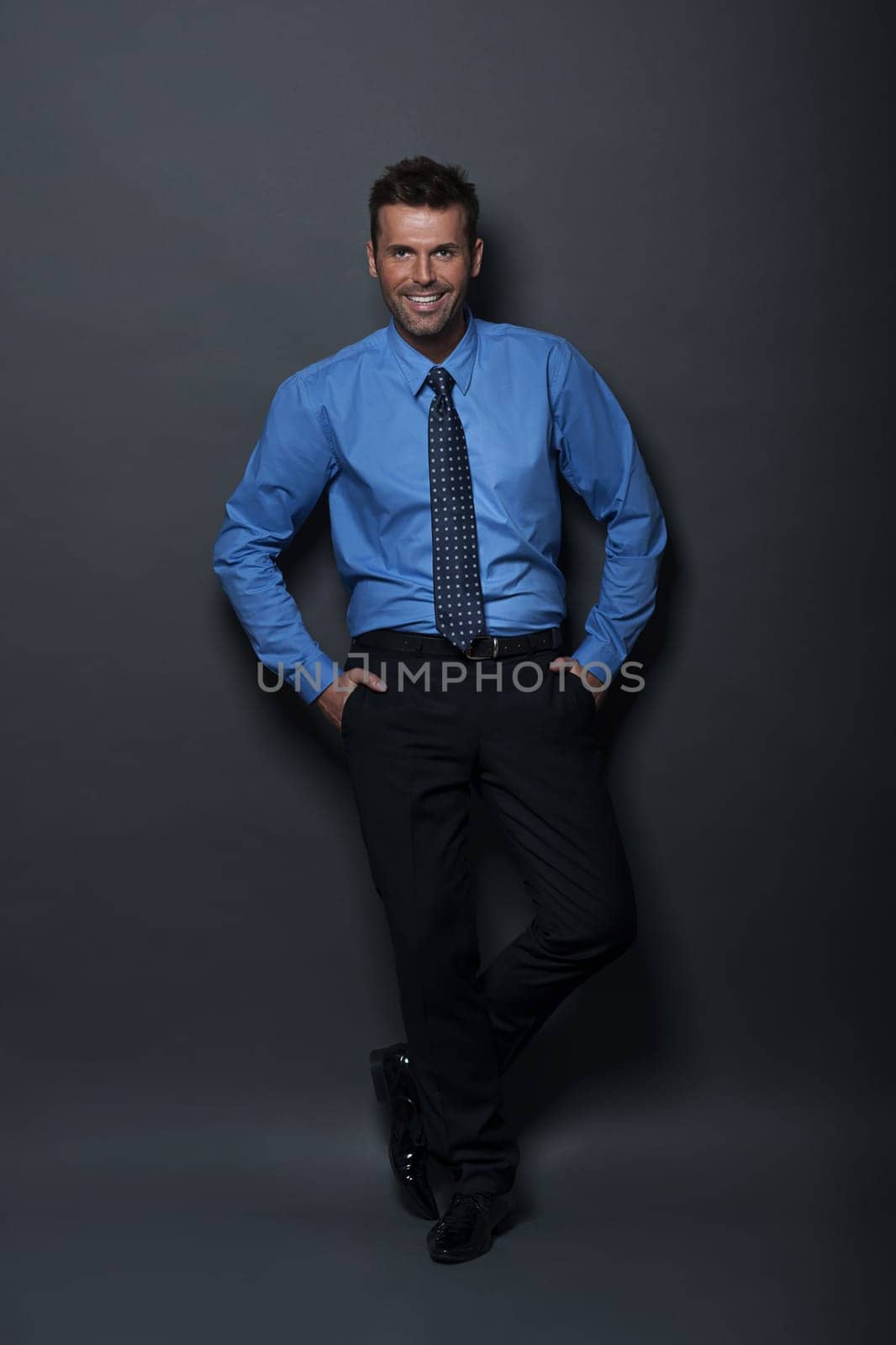 Relaxed and confident businessman looking at camera